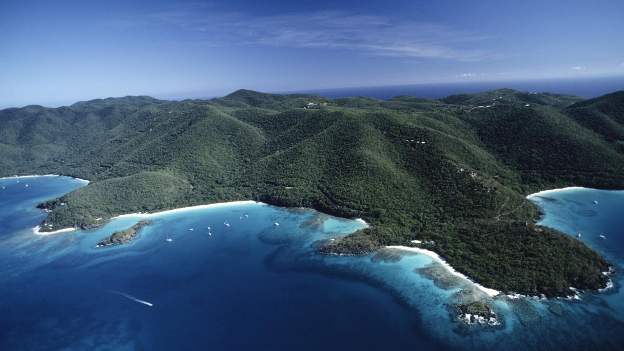 Aerial view of St. John, US Virgin Islands with lush green hills and turquoise Caribbean waters
