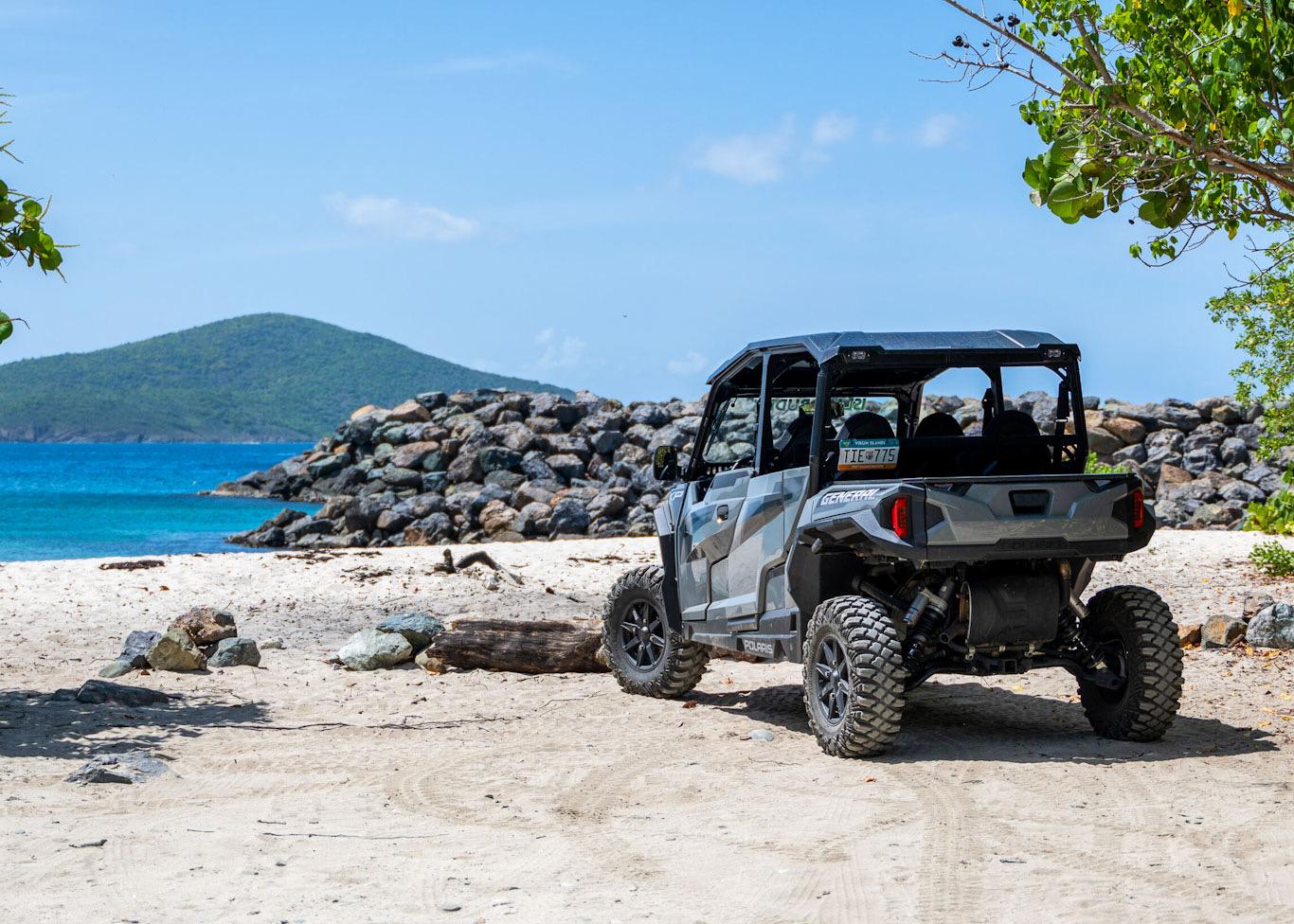 Open-air Jeep tour driving along scenic mountain roads on St. John, US Virgin Islands with turquoise ocean views