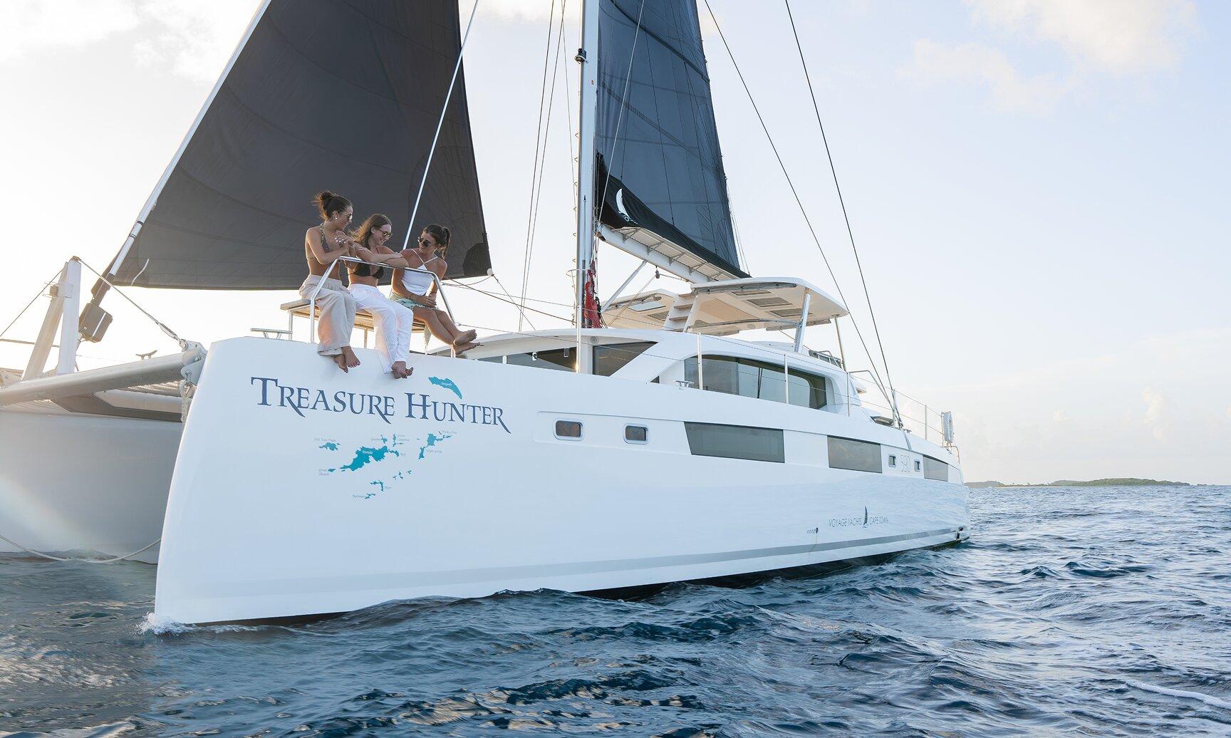 Private charter boat sailing through turquoise Caribbean waters off St. Thomas, US Virgin Islands with Charlotte Amalie harbor in the background