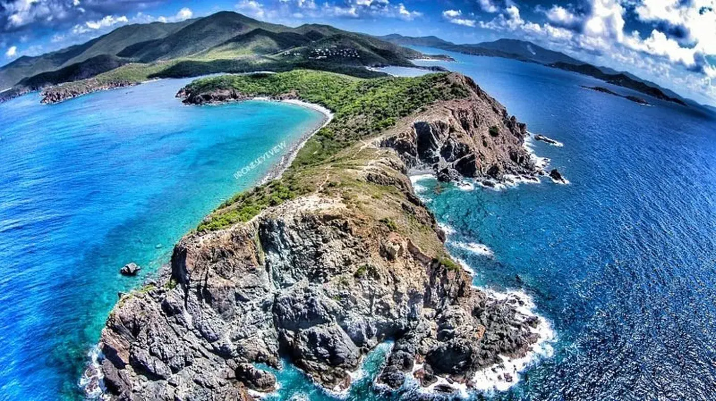 Aerial drone view of Ram Head peninsula on St. John, USVI — dramatic rocky cliffs surrounded by turquoise Caribbean waters