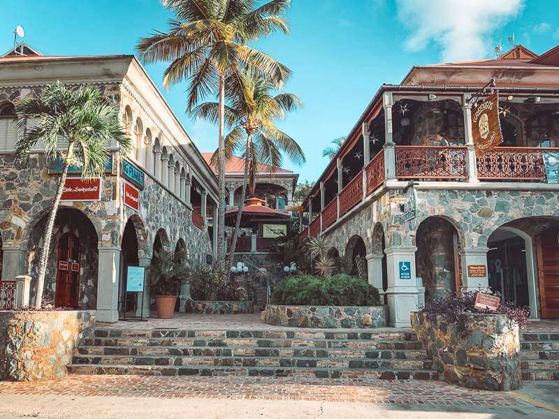 Mongoose Junction shopping center in Cruz Bay St. John with stone architecture and palm trees