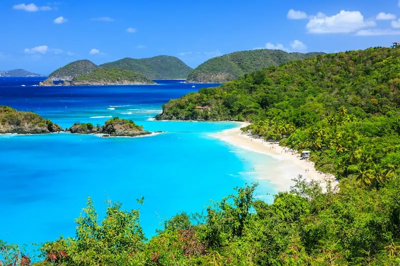 Woman floating on raft in crystal clear turquoise water at Trunk Bay St. John
