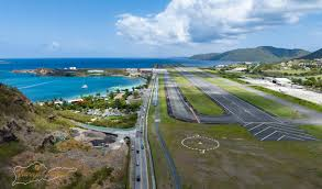 Aerial view of Cyril E. King Airport runway in St. Thomas with turquoise Caribbean water and green hills
