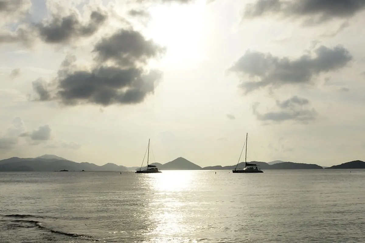 Sailboats silhouetted on the water at sunset in the US Virgin Islands