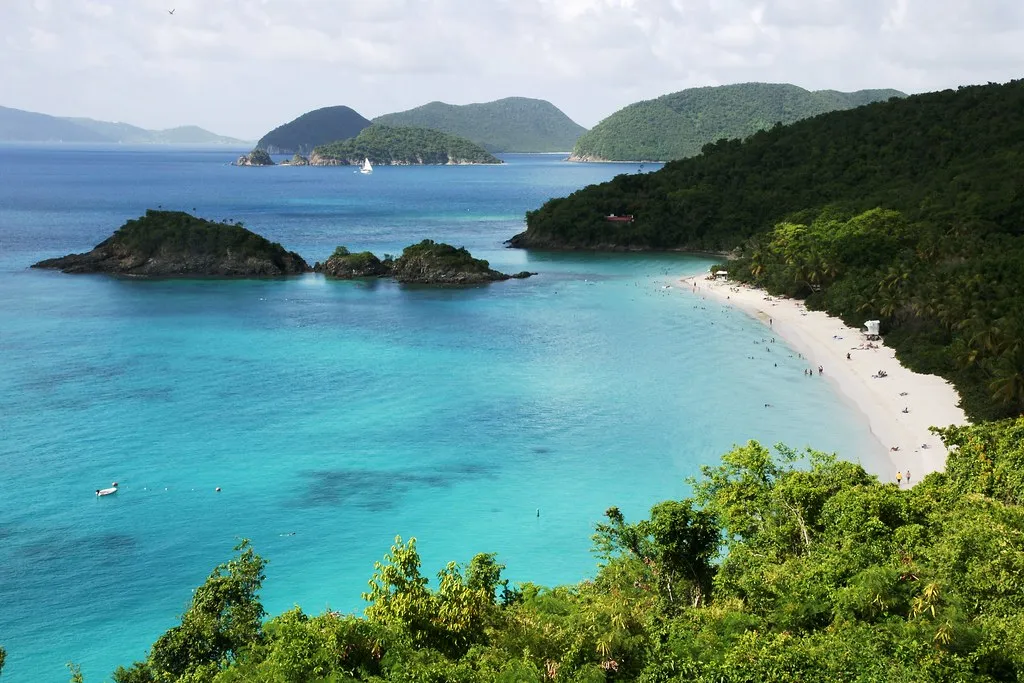 Turquoise cove with white sand beach and boats anchored offshore in the US Virgin Islands