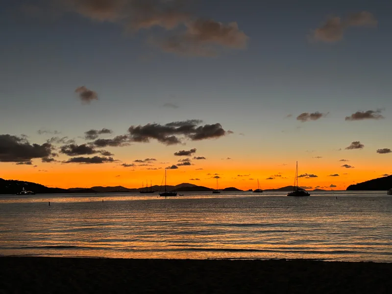 Guided sunset kayak tour along St. John's coastline with golden hour skies reflecting on calm Caribbean waters